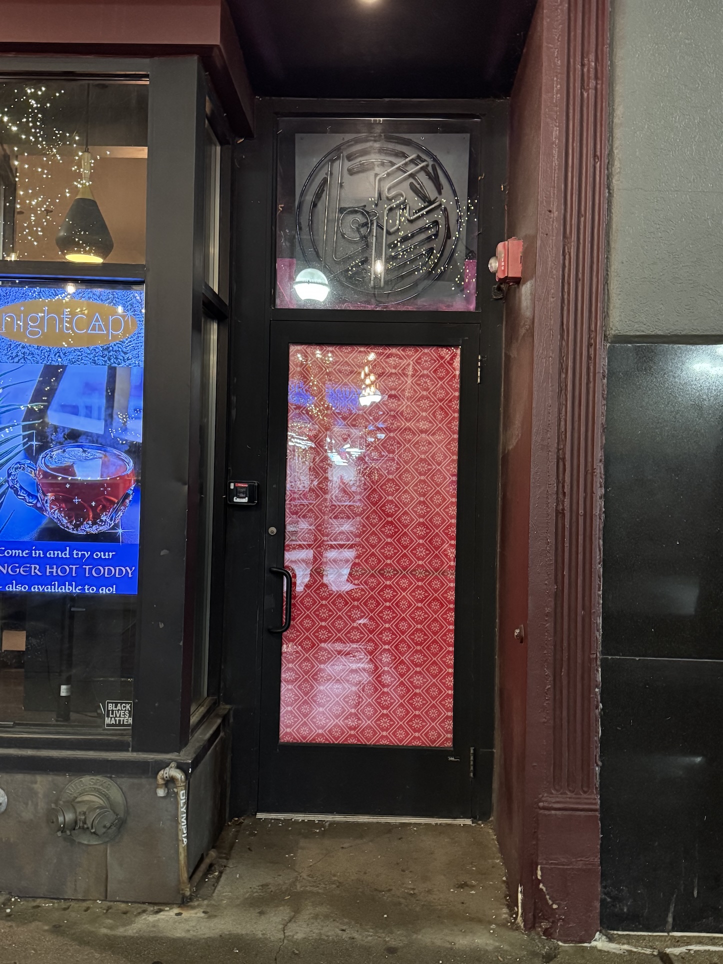 The Lo-Fi entrance door is locked shut, the window is covered with paper, and the neon Lo-Fi sign is turned off.