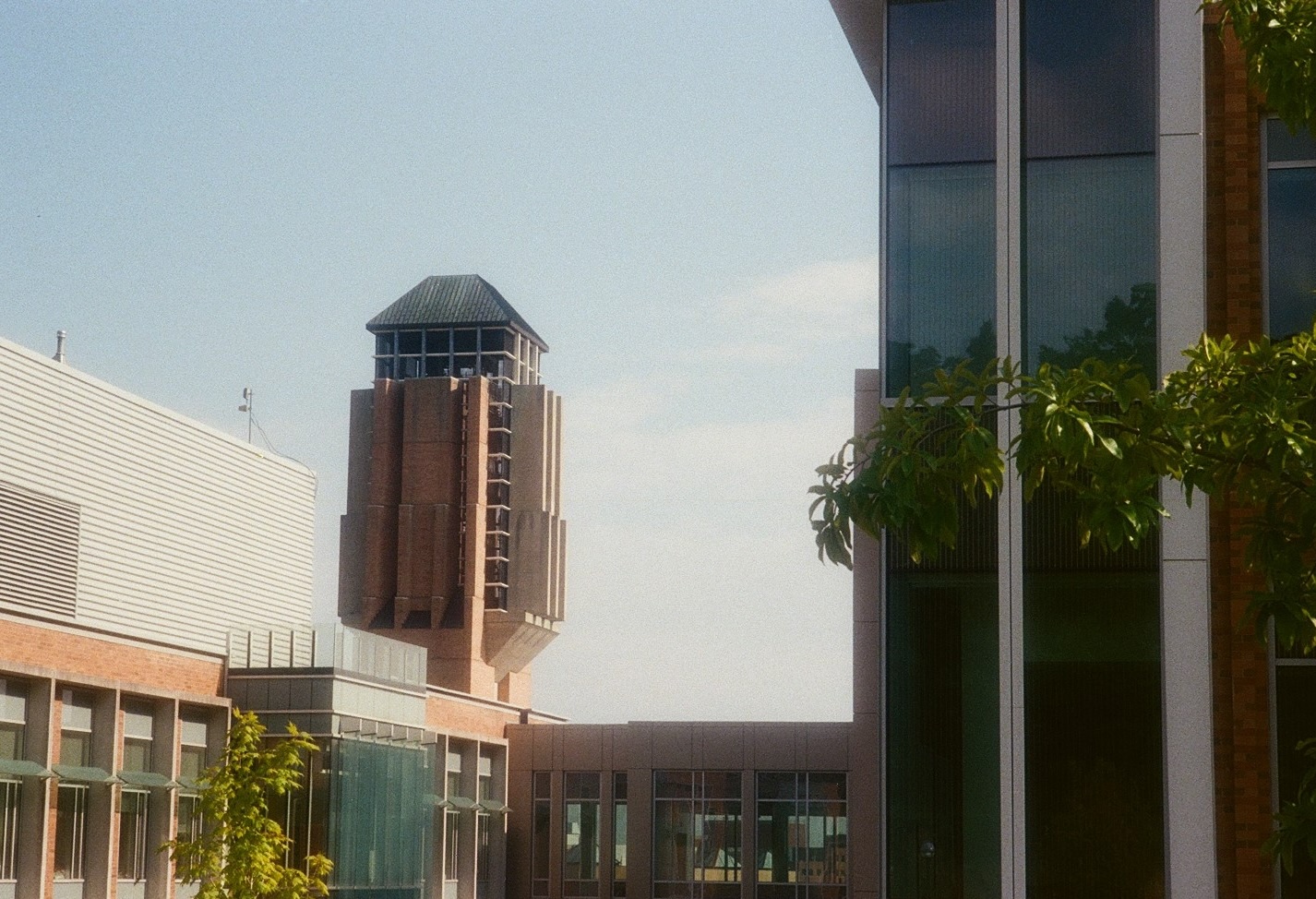 A large brick bell tower standing behind the Leinweber Building and the Bob and Betty Beyster Building.