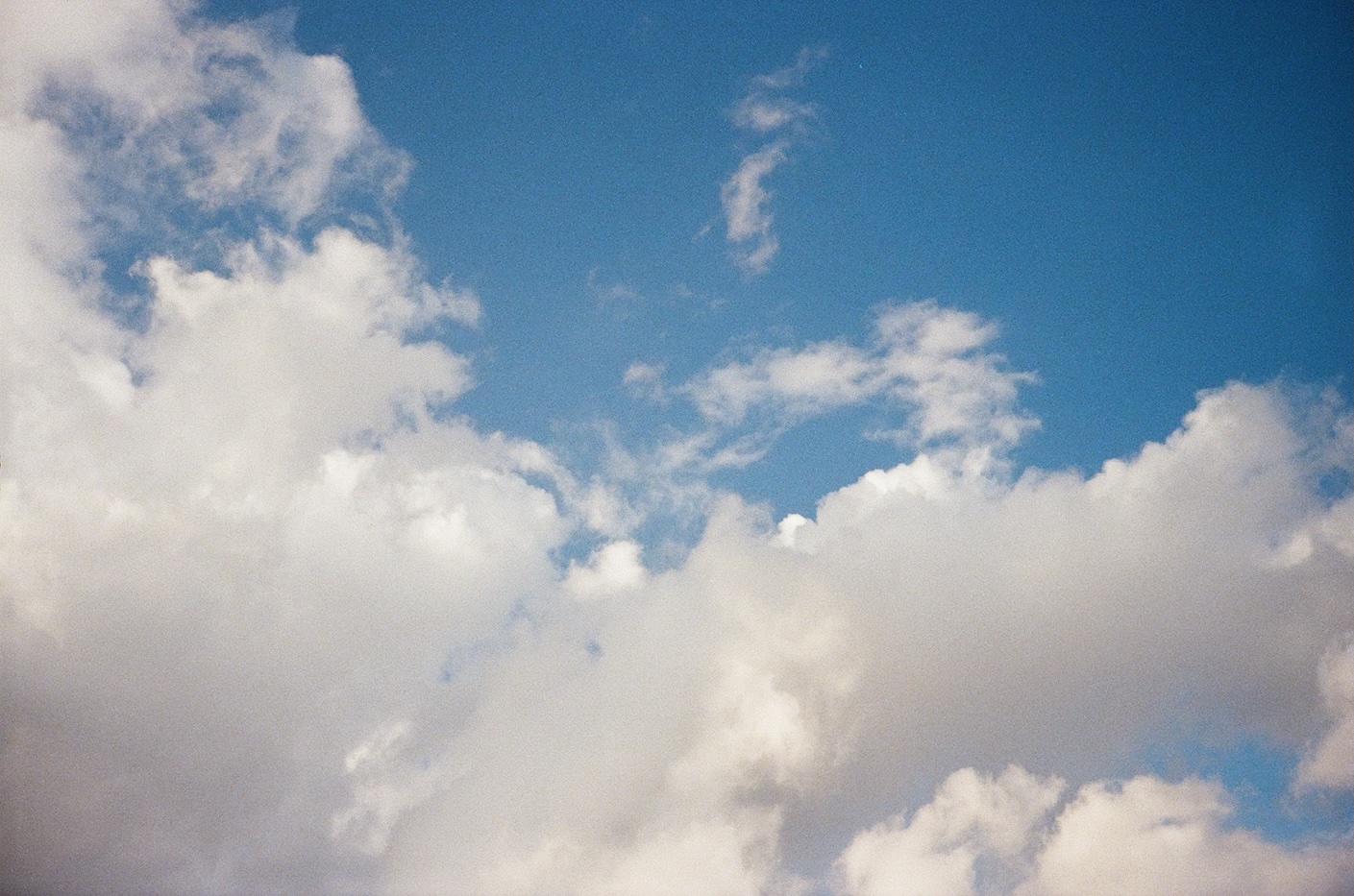Large, fluffy white clouds floating in the blue sky.