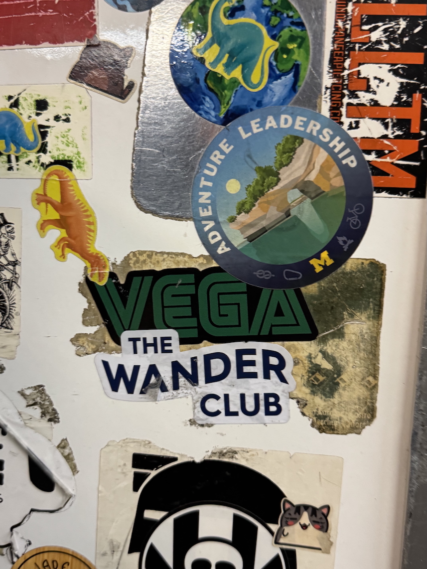 Several colourful band stickers on a white diner wall; Fleetwood Diner, Ann Arbor, Michigan