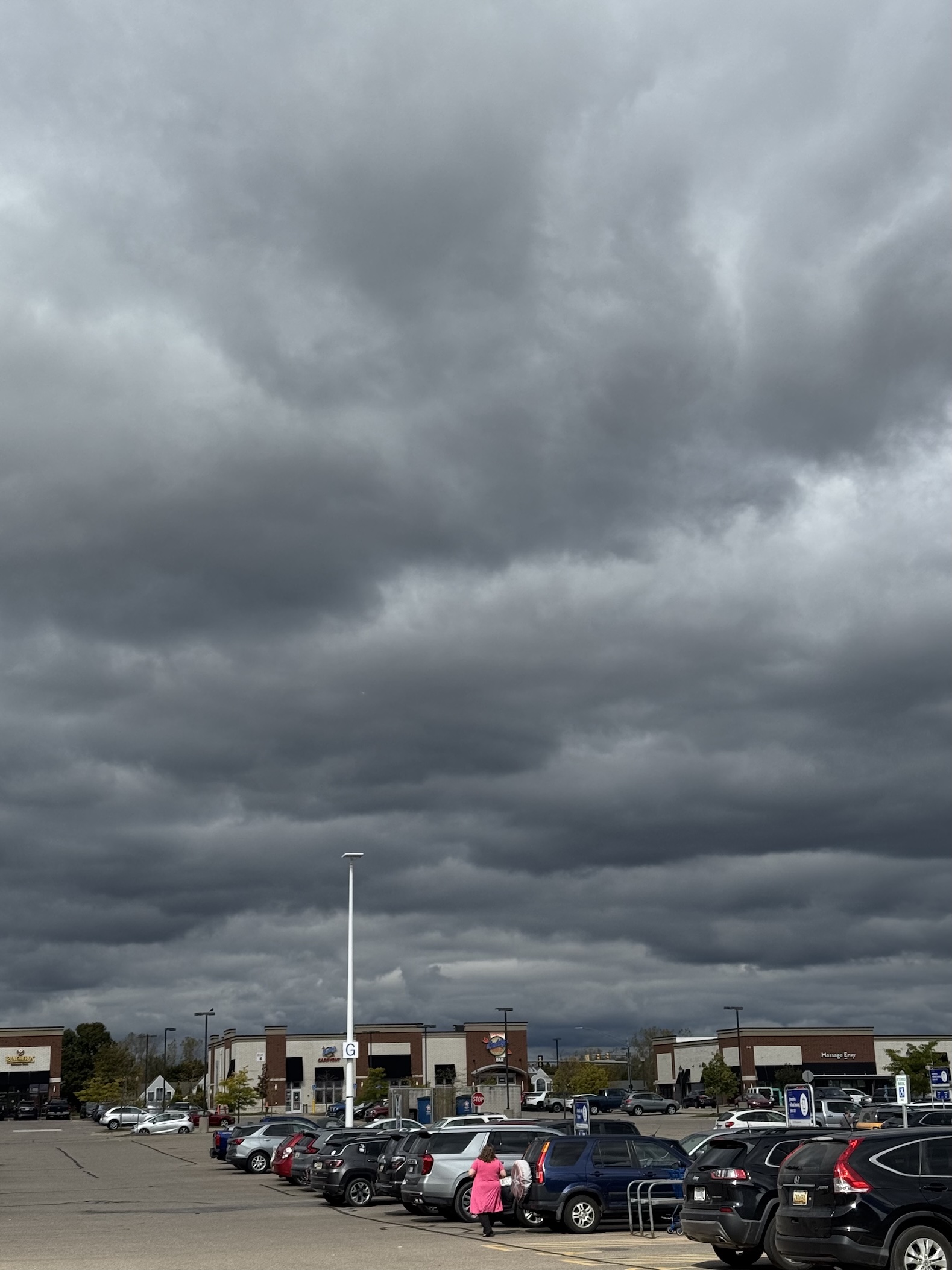Dark grey clouds above a parking lot.