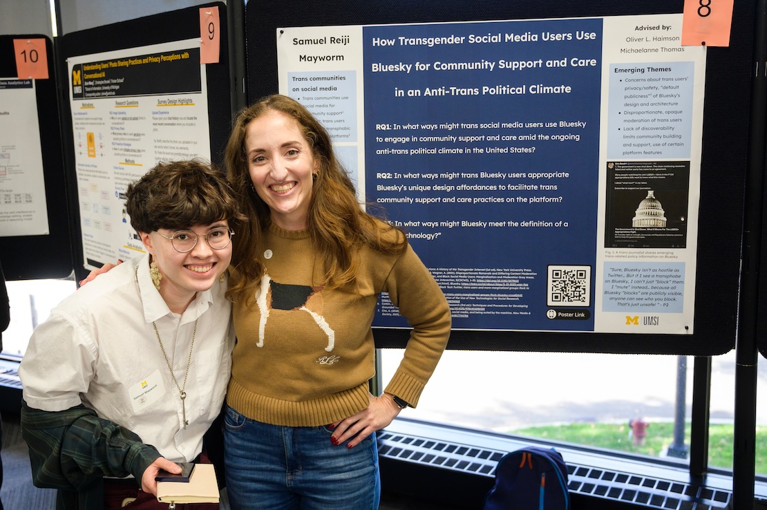A photograph of me and Dr. Michaelanne Thomas standing in front of my pre-candidacy research poster.
